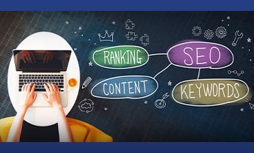 Laptop with word bubbles of ranking, content, SEO, keywords